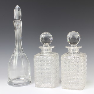 A pair of square cut glass spirit decanters and stoppers 23cm together with a mallet shaped decanter with later stopper  