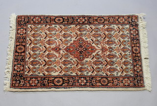 A brown and tan ground Persian Brojerd rug with central medallion within multi row borders 96cm x 62cm 
