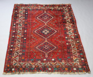 A red and blue ground Afghan rug with 3 diamonds to the centre within a multi row border 231cm x 179cm 