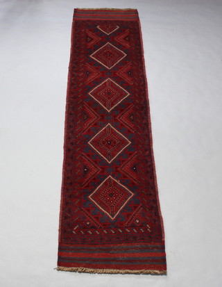 A red and blue ground Meshwani runner with 4 diamonds to the centre within a multi row border 270cm x 65cm 