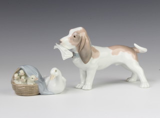 A Lladro figure of a basset hound holding a newspaper in his mouth 17cm and a ditto of a family of geese 4895 10cm 