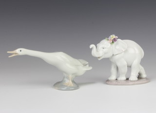 A Lladro figure of an elephant cub with flowers behind its ear 6460 10cm together with a ditto goose 6cm 