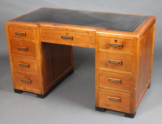 A 1930's Art Deco mahogany inverted breakfront desk with black tooled leather writing surface, fitted 1 long and 8 short drawers, raised on shaped ebonised supports 78cm h x 133cm w x 71cm d 