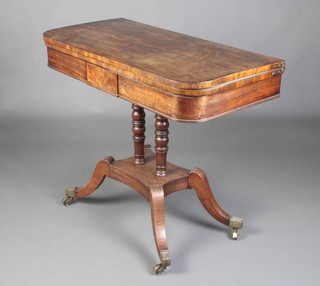 A Regency  mahogany D shaped card table raised on 2 turned columns with platform base and splayed feet ending in brass caps and castors 76cm h x  92cm w x 45cm d 