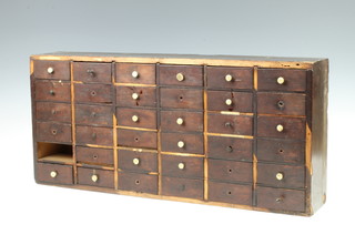 A 19th Century mahogany apothecaries cabinet fitted 36 shallow drawers and with turned ivory handles 27cm h x 59cm w x 12cm d 