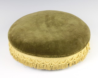 A Victorian circular footstool upholstered in green dralon, raised on 3 bun feet 9cm h x 35cm diam.  