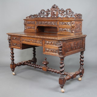 A Victorian heavily carved oak writing table, the raised superstructure with pierced and carved 3/4 gallery fitted 1 long drawer flanked by 4 short drawers with recess, the base fitted a drawer flanked by 2 short and 1 long drawer raised on later casters 134cm h x 120cm w x 70cm d 