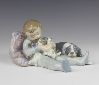 A Lladro group of a young boy with a family of dogs 1535 16cm