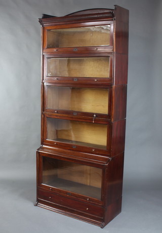 A 1920's Lebus mahogany 6 tier Globe Wernicke style bookcase with three-quarter gallery, moulded and dentil cornice, the upper section fitted 5 sections enclosed by glazed panelled doors, the base with drawer 225cm h x 88cm w x 40cm d 