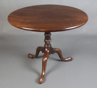 A circular Georgian mahogany snap top tea table, raised on a turned column and tripod base 76cm h x 91cm diam. 