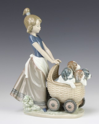 A Lladro group of a young girl pushing a pram of puppies 5364 21cm 