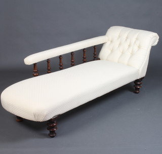 A Victorian mahogany chaise longue with bobbin turned decoration upholstered in white material, raised on bun feet 69cm h x 186cm w x 60cm d 