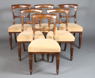A set of 6 Victorian mahogany balloon back dining chairs with carved mid rails and overstuffed seats raised on turned and reeded supports 