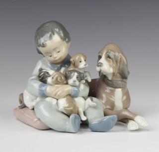 A Lladro group of a boy with a dog and puppies 5456 11cm 