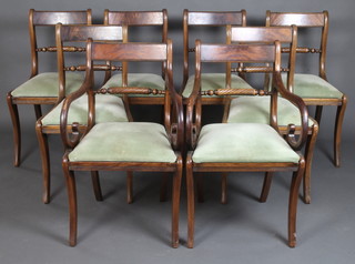 A set of 8 Regency style bar back dining chairs with rope mid rails and upholstered drop in seats, raised on sabre supports 