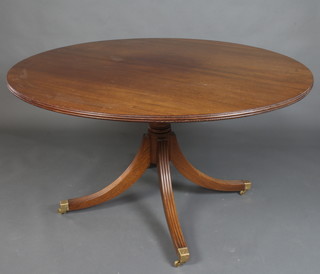 A Regency style circular mahogany snap top breakfast table, raised on a turned column with quadripartite supports ending in brass caps and casters 75cm h x 135cm diam. 