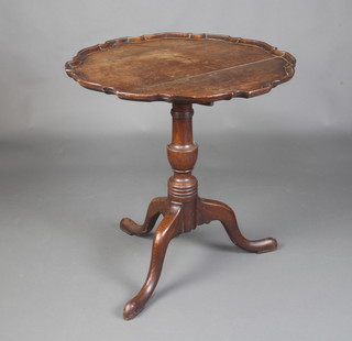 A Georgian country oak tea table with pie crust edge raised on a turned urn column support with tripod base 72cm h x 50cm 