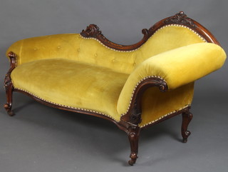 A Victorian carved walnut show frame settee upholstered in yellow buttoned material 94cm h x 192cm w x 62cm d 