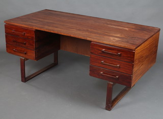 Mid Century, a rosewood finished desk fitted 6 drawers and a recess, raised on square supports 72cm h x 156cm w x 74cm d 