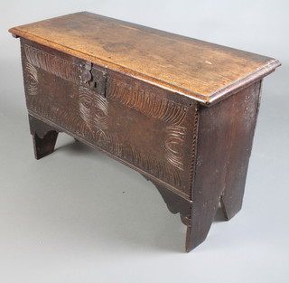 A 17th/18th Century oak coffer of panelled construction the interior fitted a candlebox 55cm h x 89cm w x 38cm d 