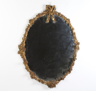 An oval plate mirror contained in a decorative gilt frame 89cm h x 69cm 