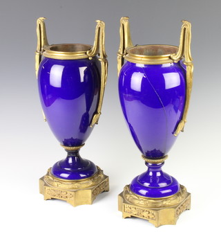 A pair of 19th Century Sevres style gilt metal mounted blue porcelain vases, raised on stepped bases, 42cm 