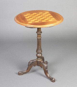 A Victorian circular games table, the top inlaid a chessboard, raised on a turned and fluted column with tripod base 68cm h x 52cm diam. 