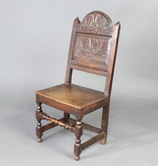 A Victorian 17th Century style carved oak hall chair with solid seat, raised on turned and block supports 