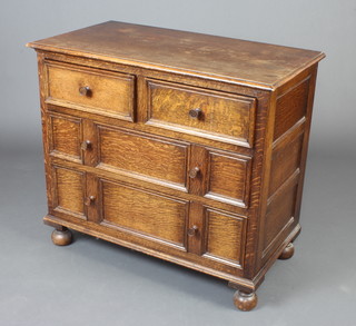 A 17th Century style oak chest of 2 short and 3 long drawers with tore handles and geometric mouldings, raised on bun feet 82cm h x 92cm w x 49cm d 