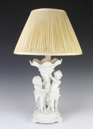 A Parian group of 2 Putti, raised on a circular base now converted to electricity 33cm 