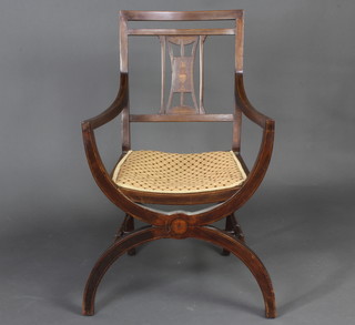 An Edwardian inlaid mahogany stick and rail back open arm carver chair with X framed support and turned stretchers 