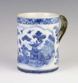 An 18th Century Chinese blue and white mug decorated with a panel of landscape, having a later metal handle, 12cm 
