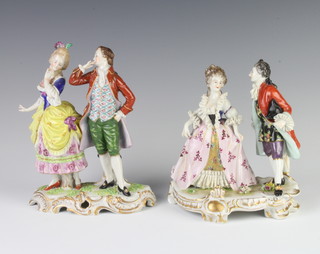 A German porcelain figure group of a lady and gentleman raised on a rococo base 17cm, a ditto 15cm  