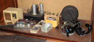 A World War Two German clockwork mine mechanism, an Air King radio model 222, 2 pairs of headphones, a handset, circular metal cased loudspeaker and other items of radio equipment 
