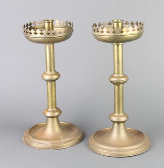 A pair of Victorian brass ecclesiastical style candlesticks with wavy rims and deep sconces 33cm h x 14cm 