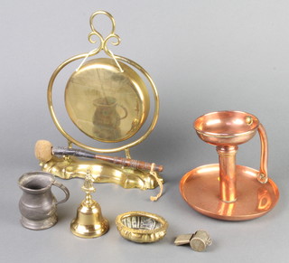 An Art Nouveau hammered copper chamber stick, the bases marked Goodnight 16cm x 17cm, a brass tea gong and stand, an oval embossed brass salt, a small hand bell, a whistle and a pewter measure 