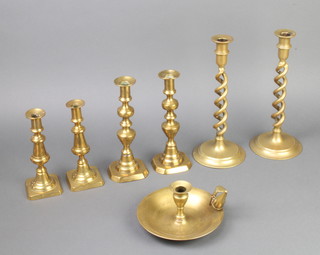 A pair of 19th Century brass spiral turned candlesticks on spreading feet 31cm h, 2 pairs of 19th Century brass candlesticks with ejectors 24cm (1 soldered) and a brass chamber stick 