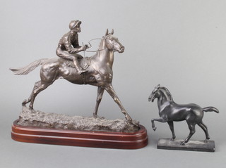 A metal figure of a walking horse raised on a rectangular base 17cm h x 15cm w x 5cm d together with a bronzed figure of a race horse with jockey 31cm x 39cm x 11cm (jockey leg f)  