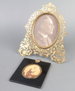 A pierced gilt metal easel photograph frame 22cm x 19cm together with a black and white portrait miniature of a lady contained in an ebonised frame 13cm x 10cm 