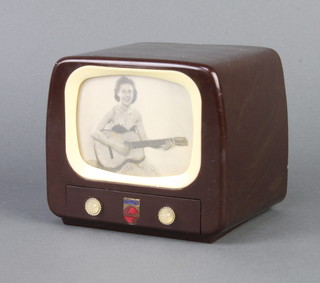 A Philips Bakelite musical box in the form of a Philips television with a figure of a lady playing a guitar 10cm x 10cm x 10cm 