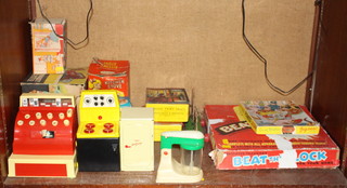 A 1960's Tudor Rose plastic model till boxed, a child's Rutland kitchen stove boxed (box worn) and a Sunny battery operated electric mixer, boxed and a Wellfreeze tin plate refrigerator boxed, a Beat The Clock Game, a Noddy plywood jigsaw puzzle etc (all boxes are showing signs of deterioration) 
