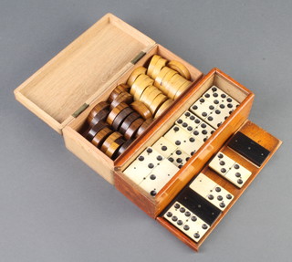 Thirty various turned wooden drafts - 15 white and 15 red together with twenty eight no.6 dominoes, in bone and ebony, cased 