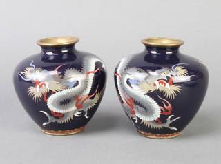 A pair of Japanese black ground cloisonne vases decorated dragons 9cm h together with a white metal and porcelain inkwell in the form of a goat cart 