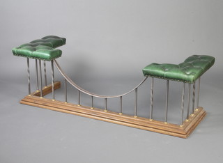 An oak and polished steel club fender upholstered in green buttoned leather 50cm h x 162cm w x 59cm d 