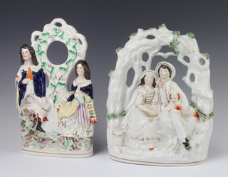 A Victorian Staffordshire arbour group of a seated couple with a spaniel 30cm, a ditto pocket watch holder 30cm 