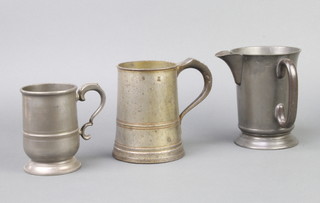 A Victorian James Yates pewter quart measure (some light corrosion), a 19th Century spouted quart measure, a pewter tankard marked Rose and Crown cast pewter