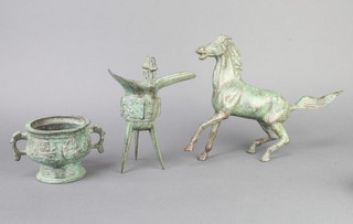 A Chinese verdigris bronze Jue jug 18cm x 15cm x 7cm, a Chinese verdigris bronze figure of a standing horse 20cm x 30cm x 5cm, ditto circular twin handle urn on a spreading foot 9cm x 10cm 