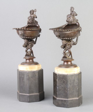 A pair of 19th Century bronze shell shaped vases surmounted by figures of Mermen and raised on Mermen dolphin bases with octagonal white marble bases, raised on black veined marble bases 37cm h x 10cm w x 17cm 