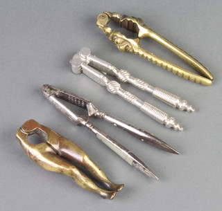 A pair of brass nut crackers in the form of a pair of legs 11cm, pair of nutcrackers with lion mask decoration 13cm and 2 other pairs of nut crackers