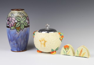 A Clarice Cliff Celtic Harvest biscuit barrel with chromium cover, a pair of Carltonware napkin holders and a Doulton vase 